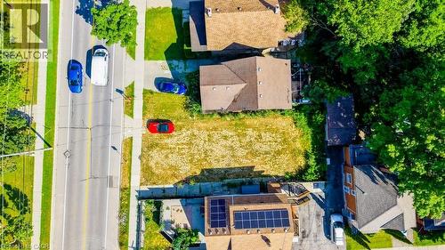 Expansive lot featuring a cleared building envelope, mature perimeter trees, and direct road frontage - 153 Courtland Avenue E, Kitchener, ON 