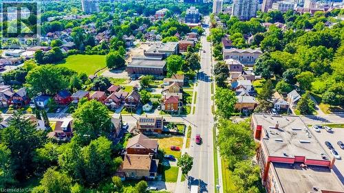 Aerial perspective showcasing a residential neighborhood with tree-lined streets, varied architectural styles, and green spaces - 153 Courtland Avenue E, Kitchener, ON 