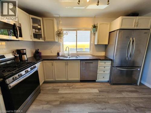 Kitchen featuring a stainless steel gas range, microwave, dishwasher, and refrigerator - 86 North Park Street, Brantford, ON 