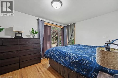 Light wood-finish flooring complements white walls and a ceiling-mounted flush light fixture - 56 Everton Place, Hamilton, ON 