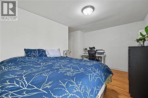 Room featuring light wood-finish flooring, white walls, and a flush-mount ceiling light - 56 Everton Place, Hamilton, ON 