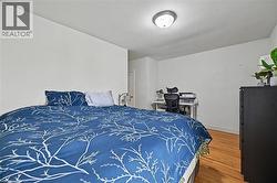 Room featuring light wood-finish flooring, white walls, and a flush-mount ceiling light - 