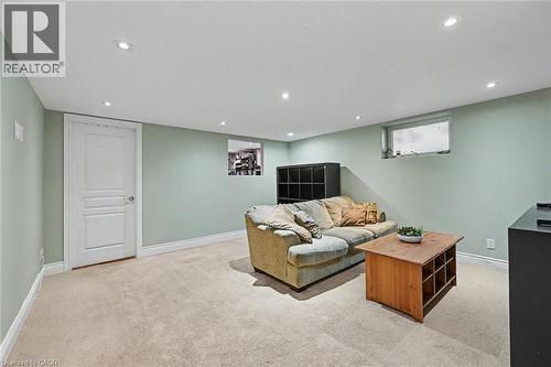 Carpeted room featuring recessed lighting, light green walls, white baseboards, and a white interior door - 56 Everton Place, Hamilton, ON 