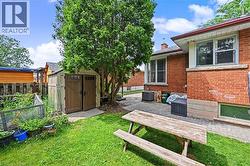 Brick exterior with multiple windows and a paver patio - 