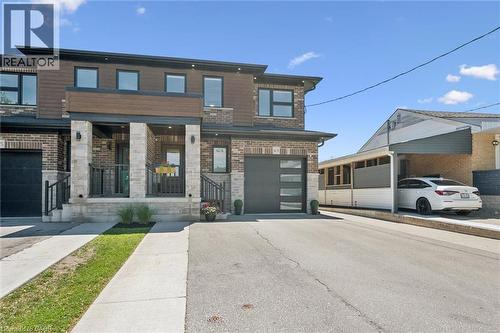 Contemporary multi-level exterior with brick and horizontal siding accents - 63 Plymouth Road, Kitchener, ON 