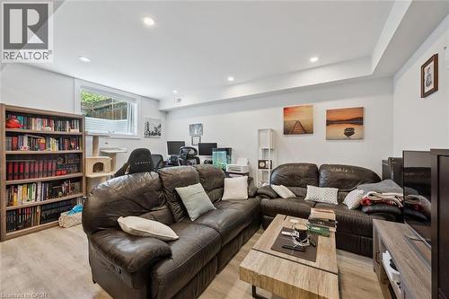 Recreation room featuring recessed lighting, wood-finish flooring, a window, and painted walls - 63 Plymouth Road, Kitchener, ON 