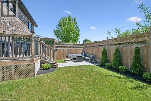 Expansive backyard featuring a manicured lawn and a paver patio - 63 Plymouth Road, Kitchener, ON 