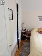 Light-toned walls with painted trim, wood-finish flooring, and area rug - 