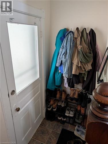 Entryway with tile flooring, a white paneled door featuring a frosted glass insert, and neutral wall tones - 15 Martin Street, Kitchener, ON 