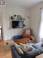 Light-toned wood-finish flooring complements the neutral wall color - 