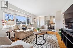 Living room featuring light wood-type flooring and healthy amount of natural light - 