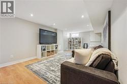 Living room with light wood finished floors and recessed lighting - 