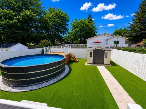 Cour - 117 Rue Hébert, Châteauguay, QC - Outdoor With Above Ground Pool With Backyard
