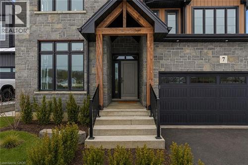 Stone facade with contrasting wood beam entryway - 7 Bartlett Avenue, Grimsby, ON 