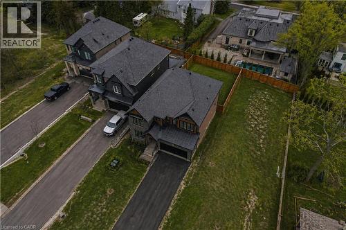 Expansive lot featuring a large green space, partial fencing, and mature trees - 7 Bartlett Avenue, Grimsby, ON 