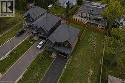 Expansive lot featuring a large green space, partial fencing, and mature trees - 