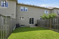 Private fenced yard with a manicured lawn - 