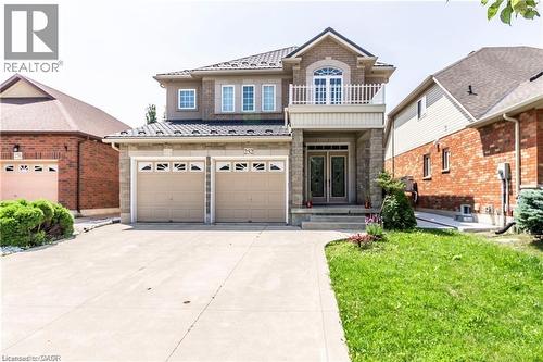 Stone and brick exterior featuring a covered front entry with double doors and a second-story balcony - 252 Thorner Drive Unit# Basement, Hamilton, ON 