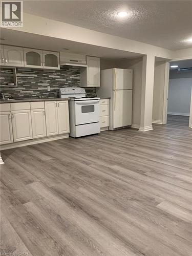 Kitchenette featuring white cabinetry, a tiled backsplash, and recessed lighting - 58 Farrier Drive Unit# Basement, Kitchener, ON - Indoor Photo Showing Kitchen