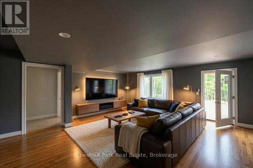 AI concept of basement walk out tv room - 23 Maple Ridge Road, Nipissing, ON - Indoor Photo Showing Living Room