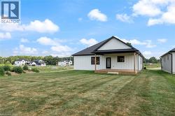 Modern white siding exterior with a dark roof and trim - 