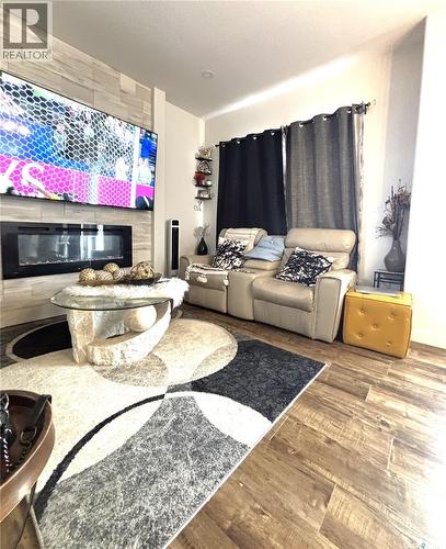 254 Aniskotaw Manor, Saskatoon, SK - Indoor Photo Showing Living Room With Fireplace