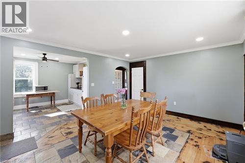 Open-concept dining area with recessed lighting, crown molding, and light blue walls - 97 Smith Road, Hamilton, ON 