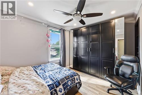 Recessed lighting and a ceiling fan illuminate this space featuring crown molding and wood-finish flooring - 97 Smith Road, Hamilton, ON 