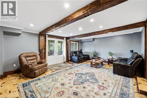 Living space featuring exposed timber beams, recessed lighting, and wood-finish flooring - 97 Smith Road, Hamilton, ON 