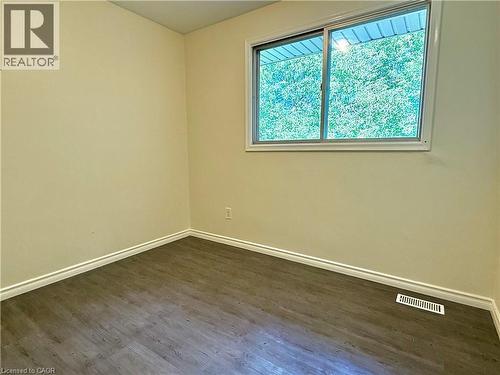 Room featuring wood-finish flooring, light-toned walls, and white baseboards - 62 Bond Street Unit# 3, Kitchener, ON - Indoor Photo Showing Other Room