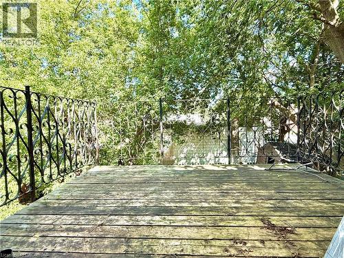 Wood-plank outdoor deck area with decorative wrought-iron railing - 62 Bond Street Unit# 3, Kitchener, ON - Outdoor