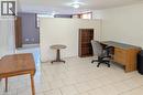 Spacious tiled flooring area featuring a partial room divider, recessed lighting, and a distinct separate room entrance - 98 Kipling Road Unit# 2, Hamilton, ON 