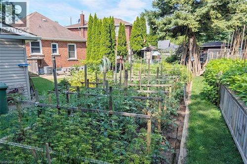 Expansive garden area featuring multiple planted beds and a grassy pathway - 98 Kipling Road Unit# 2, Hamilton, ON 