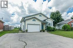 Contemporary home with light-colored siding, a dark blue entry door, and white trim accents - 
