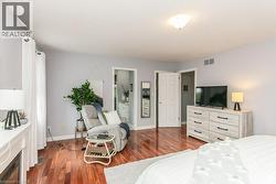 Warm wood-finish flooring complements light gray walls - 