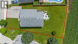 Expansive property featuring a large green lawn, a multi-level wooden deck, and mature trees - 