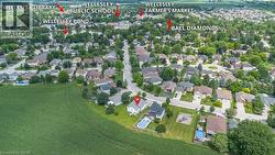 Aerial perspective showcasing a residential neighborhood bordering agricultural fields - 