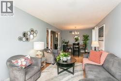 Living area with light blue walls and wood-finish flooring - 
