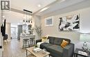 Open-concept living space featuring wood-finish flooring and recessed lighting - 33 Hawthorne Avenue, Hamilton, ON 