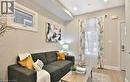 Living space featuring wood-finish flooring, recessed ceiling lighting, and a white entry door with frosted glass inserts - 33 Hawthorne Avenue, Hamilton, ON 