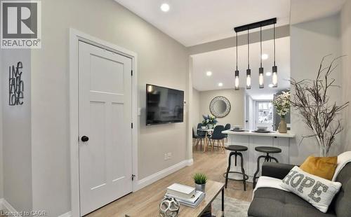 Open-concept living space with wood-finish flooring - 33 Hawthorne Avenue, Hamilton, ON 