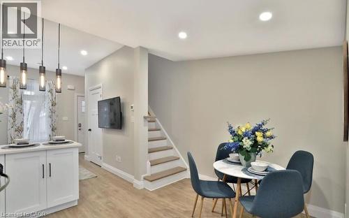 Open-concept dining area featuring recessed lighting and wood-finish flooring - 33 Hawthorne Avenue, Hamilton, ON 