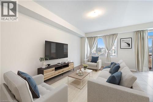 Bright living space featuring a large window, light-colored walls, and mixed flooring with wood-finish and tile sections - 61 Vanilla Trail, Thorold, ON 