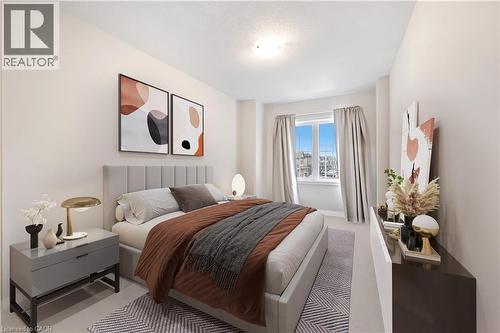 Bright bedroom featuring a large window, neutral wall paint, overhead lighting, and soft carpet flooring - 61 Vanilla Trail, Thorold, ON 