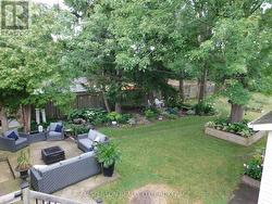 VIEW OF PATIO AND YARD FROM DECK - 
