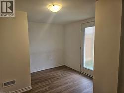 Spare room with dark wood finished floors and baseboards - 