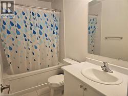 Bathroom with shower / bathtub combination with curtain, vanity, and tile patterned flooring - 