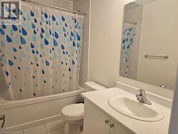 Full bath featuring shower / tub combo, vanity, and tile patterned floors - 