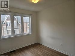 Empty room with dark wood finished floors and a textured ceiling - 