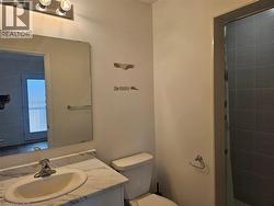 Bathroom with vanity and tiled shower - 